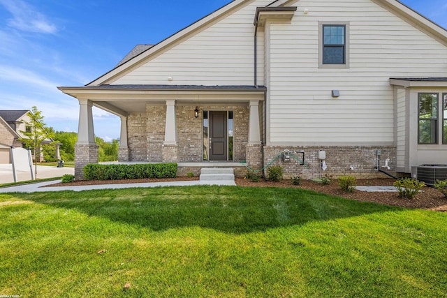 view of front facade with a porch, central AC, and a front yard