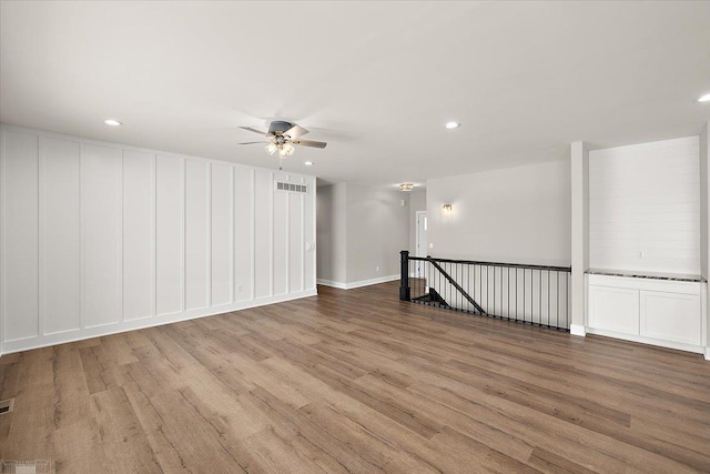 spare room featuring ceiling fan and light hardwood / wood-style floors