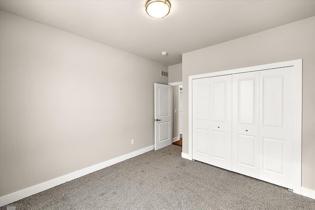 unfurnished bedroom featuring carpet floors and a closet