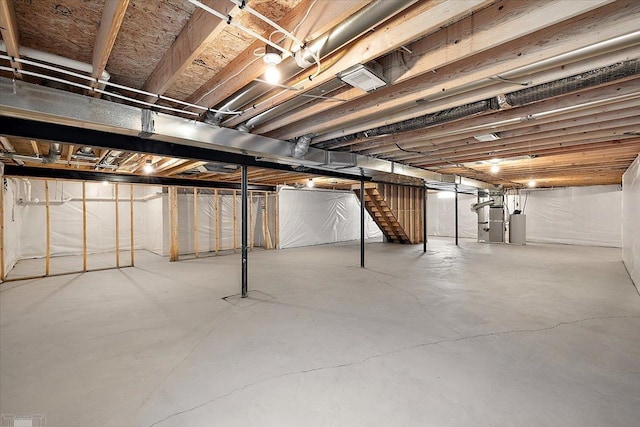 basement featuring heating unit and gas water heater