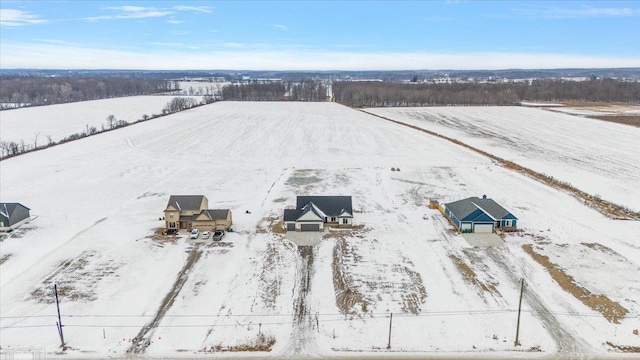 snowy aerial view featuring a rural view