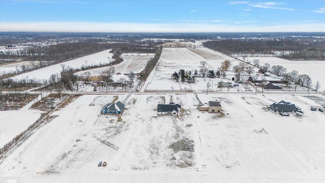 snowy aerial view featuring a rural view