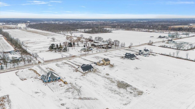 snowy aerial view featuring a rural view