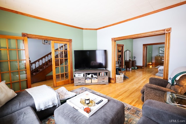 living room featuring crown molding and hardwood / wood-style flooring