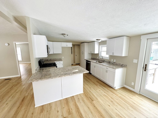 kitchen with white cabinetry, light hardwood / wood-style flooring, black dishwasher, light stone countertops, and stove