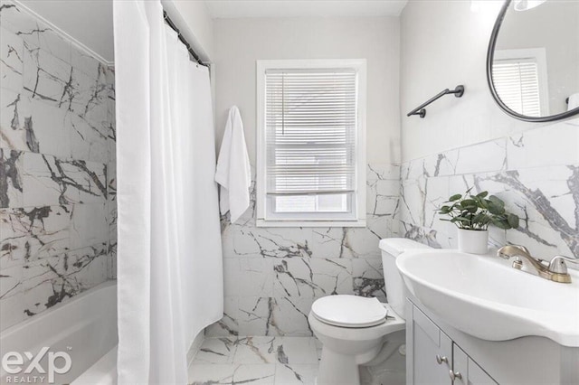 full bathroom with vanity, toilet, tile walls, and shower / bath combo