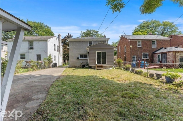 rear view of house with a lawn