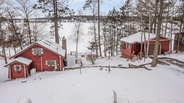 yard layered in snow with an outdoor structure