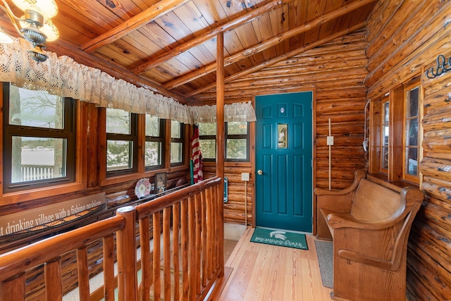 entrance foyer with rustic walls, wood ceiling, wood-type flooring, high vaulted ceiling, and beamed ceiling