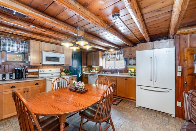 kitchen with sink, white appliances, beam ceiling, decorative light fixtures, and wooden ceiling