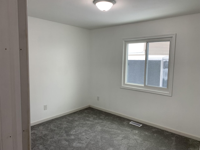 empty room with dark colored carpet