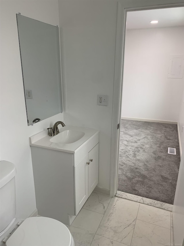 bathroom featuring vanity and toilet