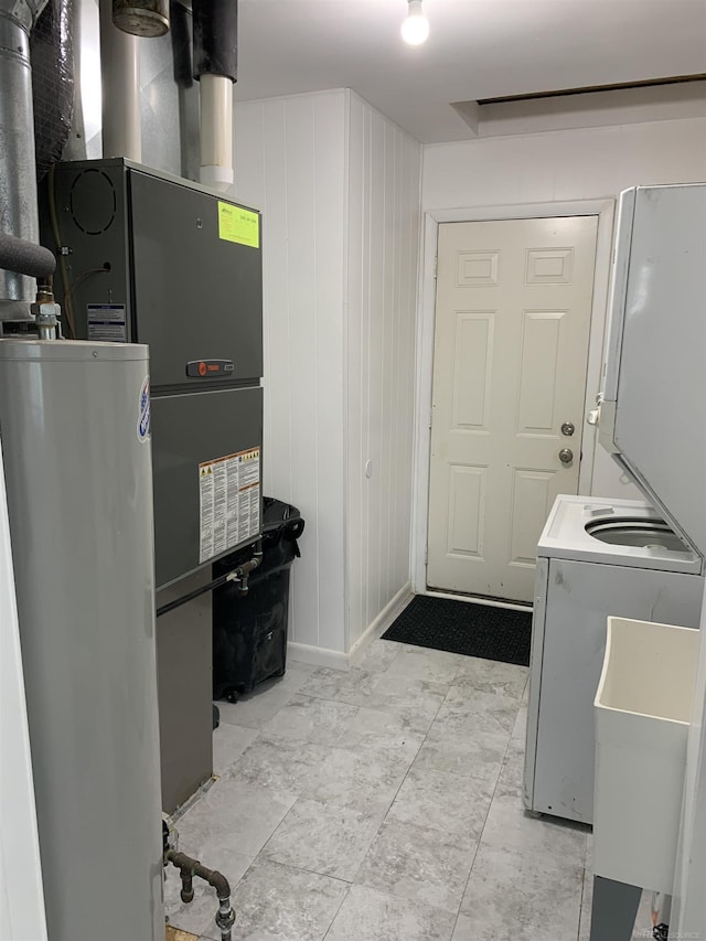 washroom featuring washer / clothes dryer, sink, and water heater