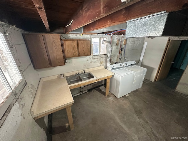 basement with sink and washer and clothes dryer