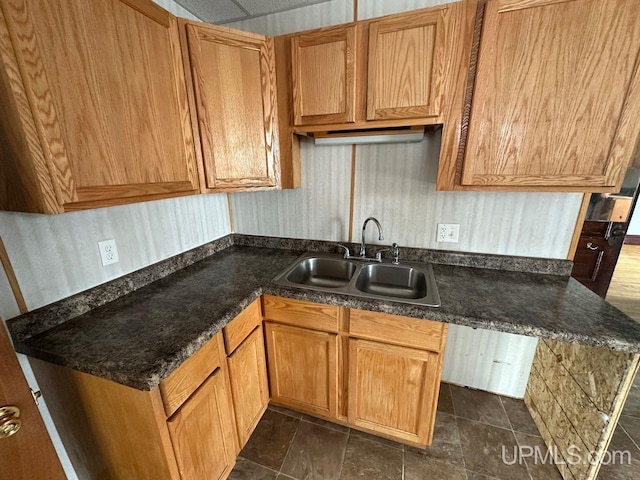 kitchen featuring dark stone countertops and sink