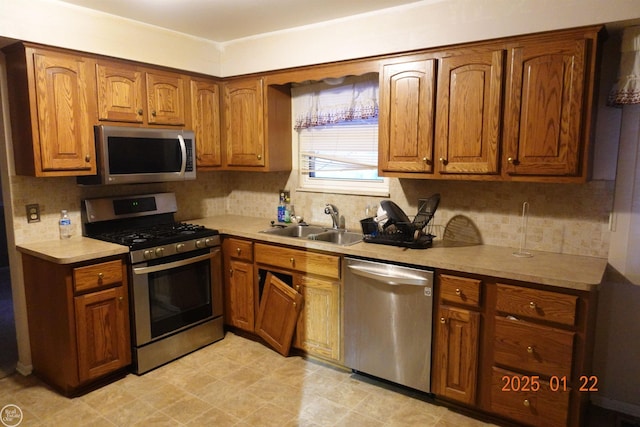 kitchen with tasteful backsplash, stainless steel appliances, and sink