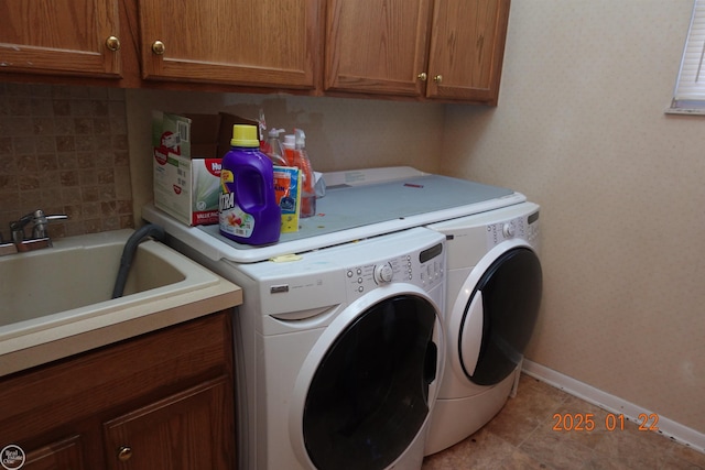 clothes washing area featuring cabinets, washer and dryer, sink, and light tile patterned floors