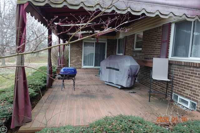 wooden terrace featuring grilling area