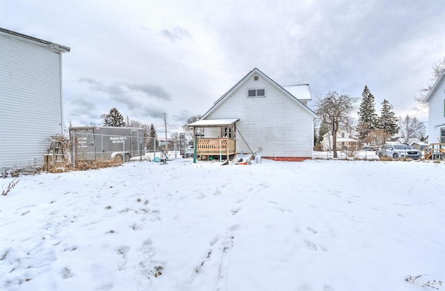 snow covered house with a deck