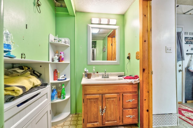 bathroom with vanity and a textured ceiling