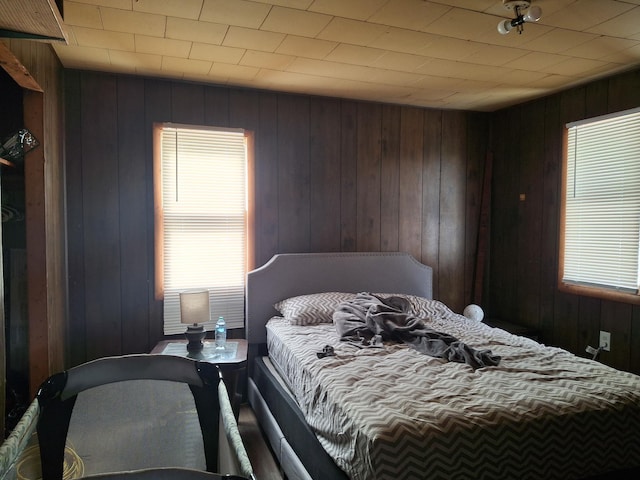 bedroom with wood walls