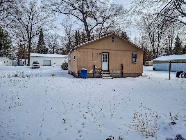 view of snow covered back of property