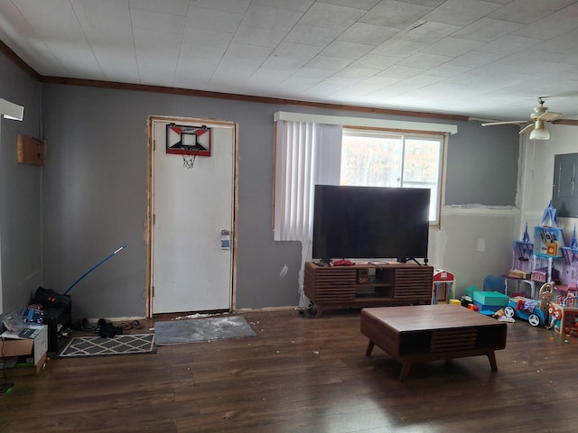 interior space with ornamental molding, dark wood-type flooring, and ceiling fan