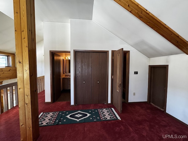 additional living space featuring vaulted ceiling and dark carpet