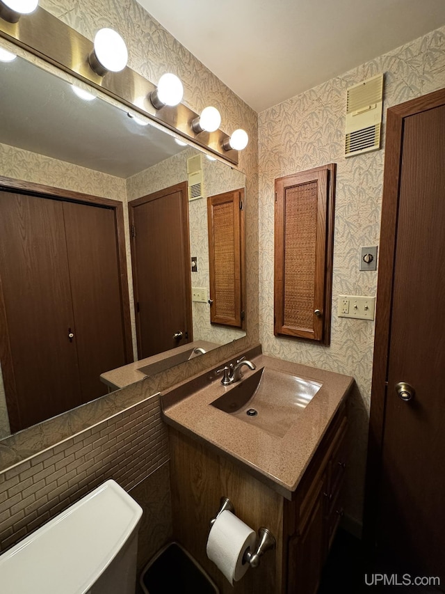 bathroom featuring vanity and toilet