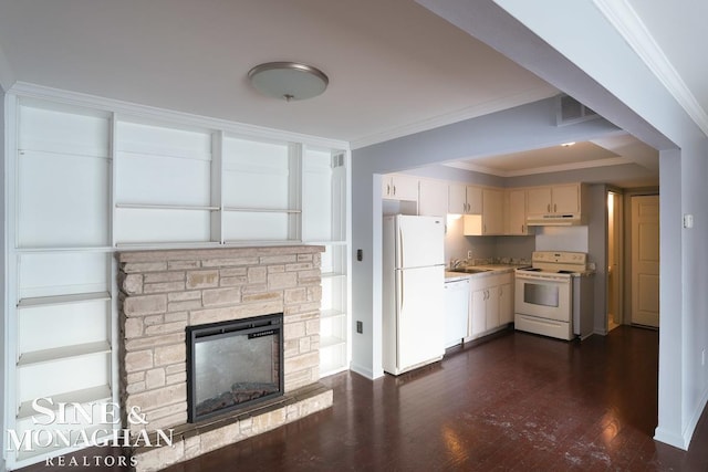 kitchen featuring sink, crown molding, white appliances, cream cabinets, and a fireplace