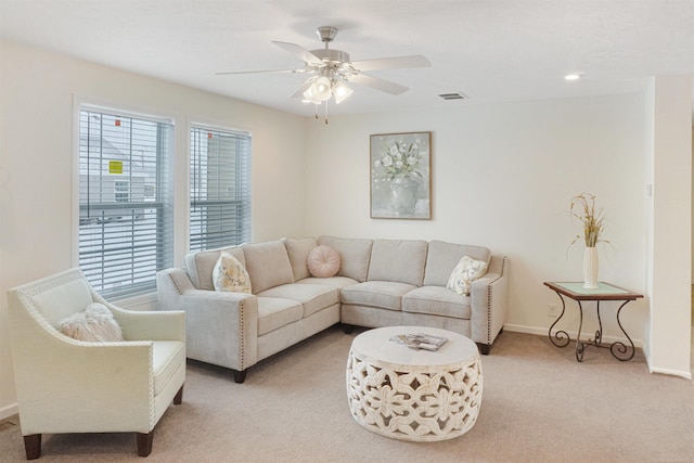 living room with ceiling fan and light colored carpet