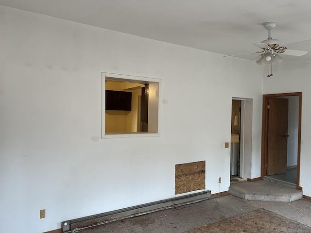 spare room featuring ceiling fan and baseboard heating