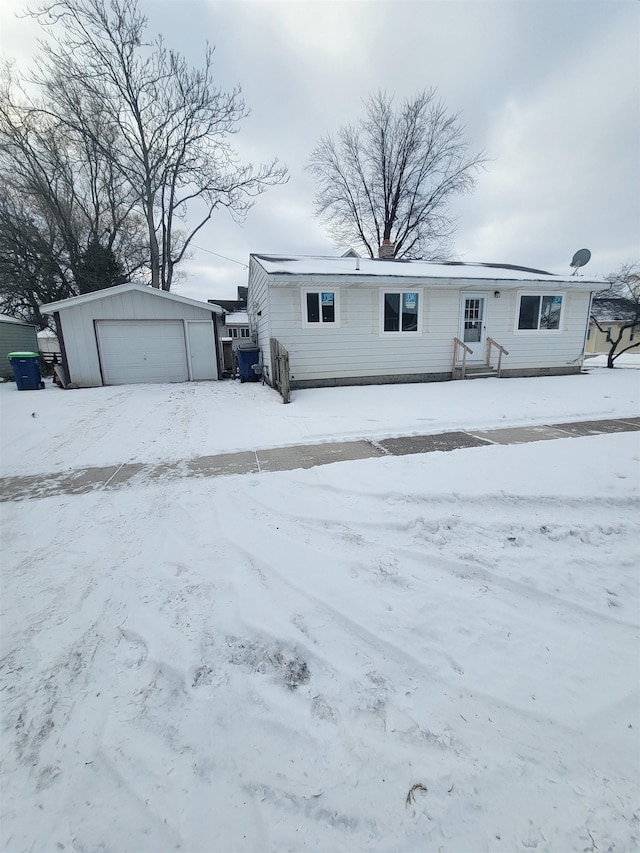 view of front facade featuring an outbuilding and a garage