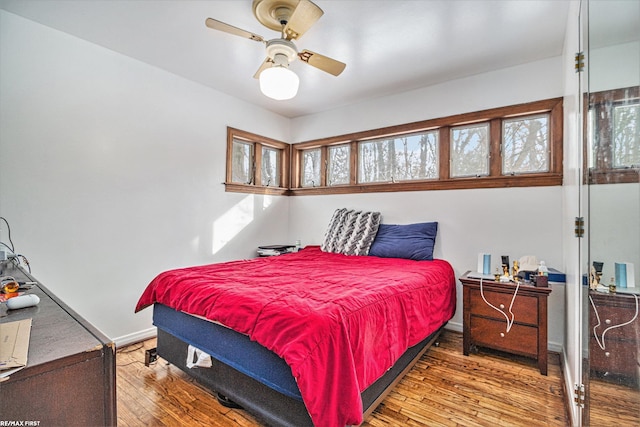 bedroom featuring wood-type flooring and ceiling fan