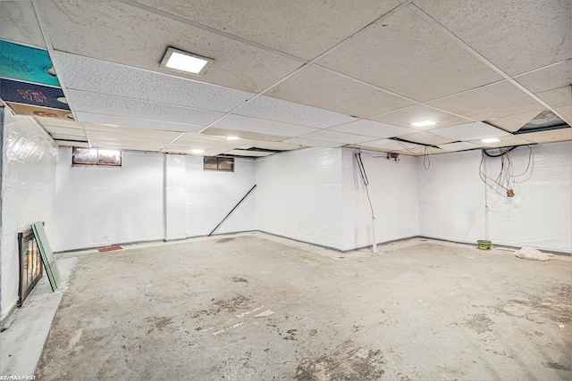 basement featuring a paneled ceiling