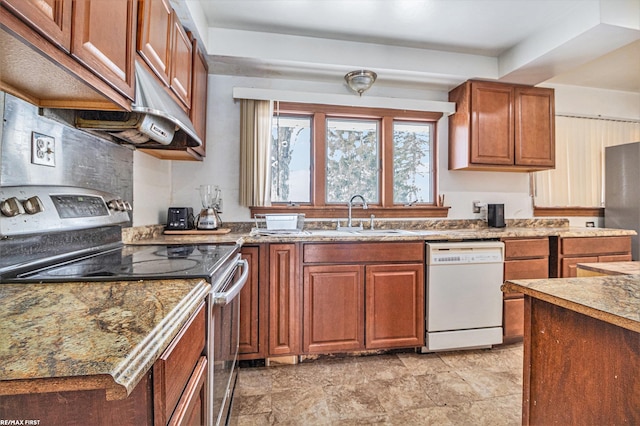 kitchen featuring appliances with stainless steel finishes, light stone countertops, and sink