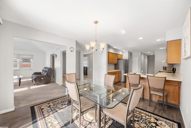 dining area featuring dark hardwood / wood-style floors and a notable chandelier