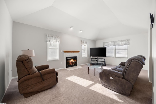 carpeted living room with lofted ceiling