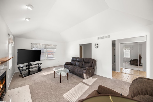 living room with lofted ceiling and light colored carpet