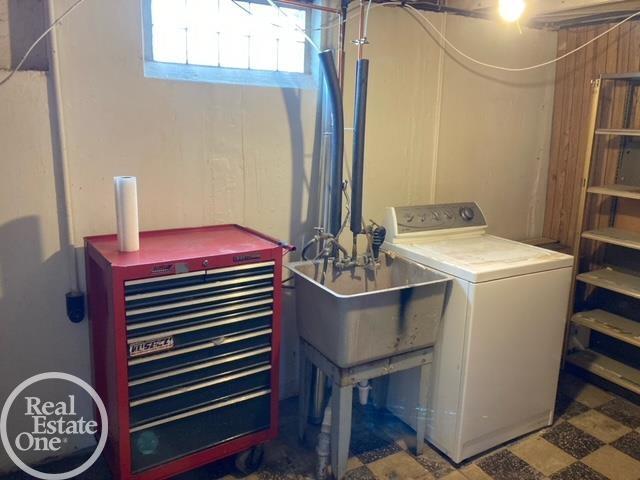 clothes washing area with washer / dryer, laundry area, and tile patterned floors