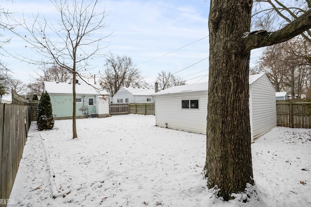 yard covered in snow featuring an outdoor structure