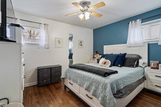 bedroom with dark hardwood / wood-style flooring and ceiling fan