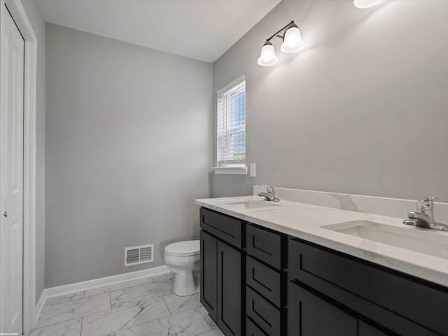 bathroom featuring vanity and toilet