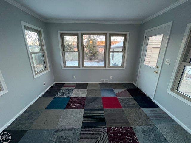 unfurnished room with crown molding and plenty of natural light