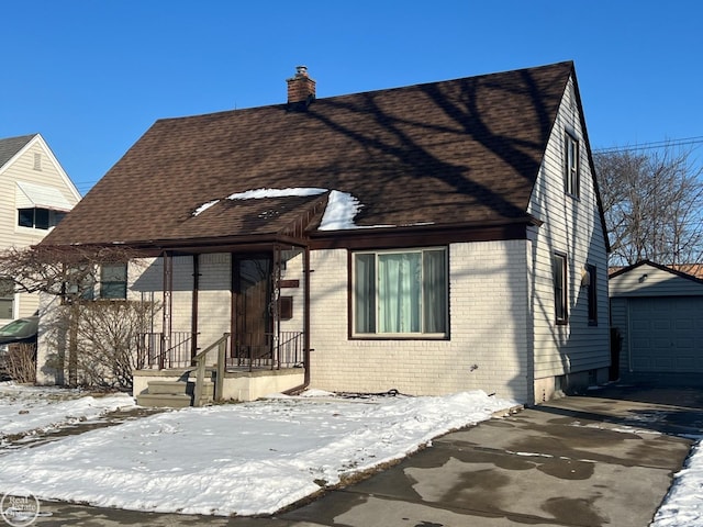 view of front of house featuring a garage and an outdoor structure