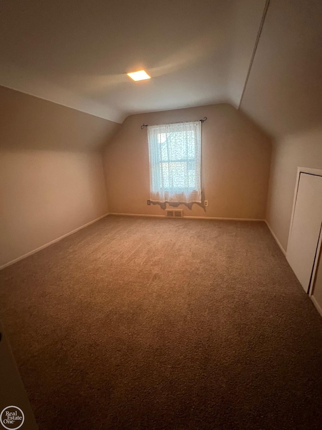 bonus room featuring lofted ceiling and carpet floors