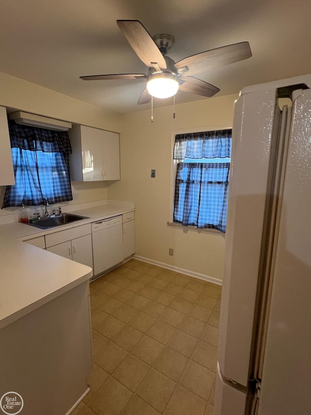 kitchen with white cabinetry, sink, ceiling fan, and white appliances