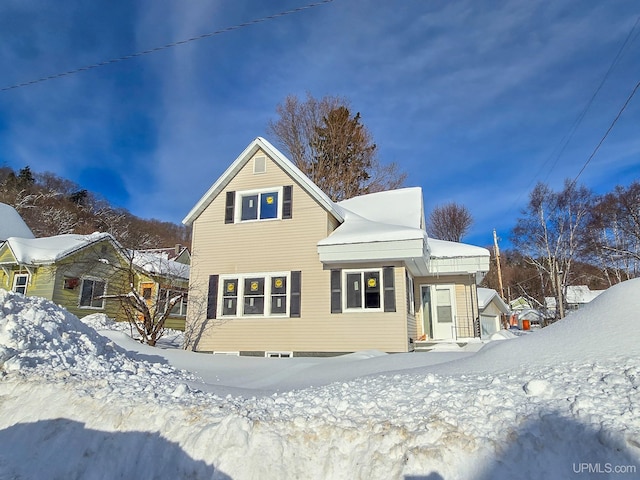 view of snow covered rear of property