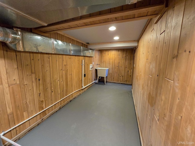 basement with sink and wood walls