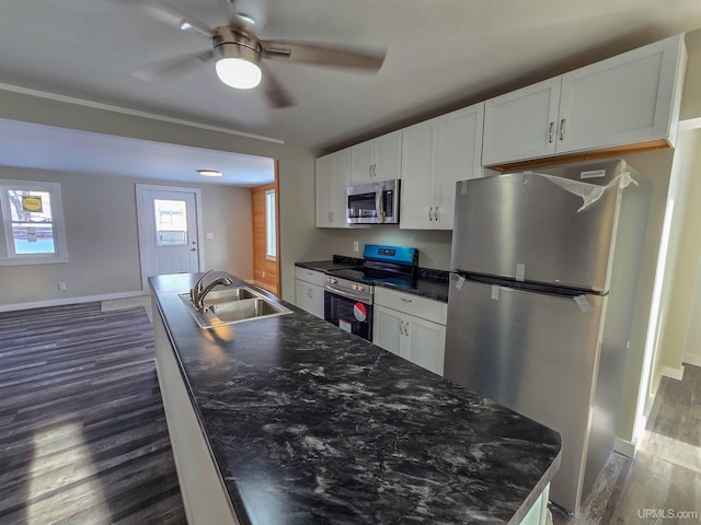 kitchen featuring stainless steel appliances, sink, and white cabinets